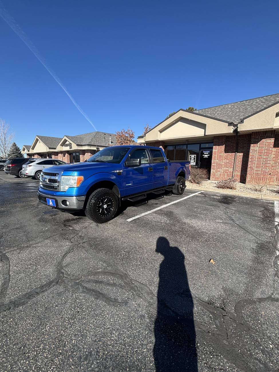 Blue Ford F-150 truck after a full exterior wash and wax