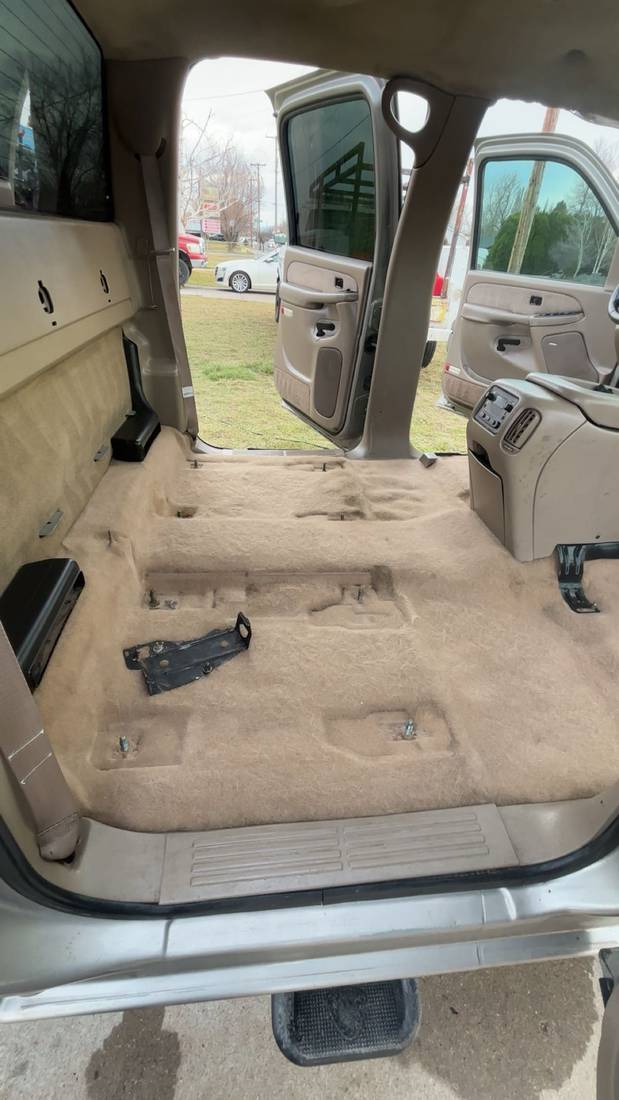 Vacuumed tan carpet cargo area with door open